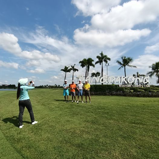 5 people people standing grass sky and palm trees