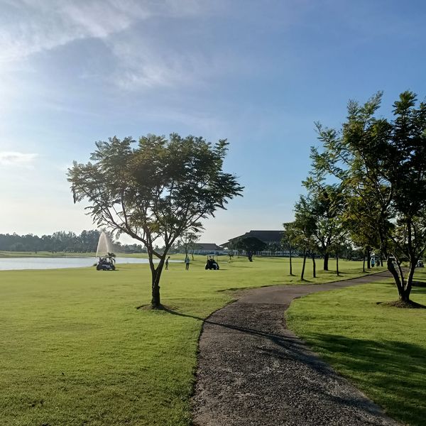 Bangpakong Riverside Country Club 4 people tree sky grass and nature