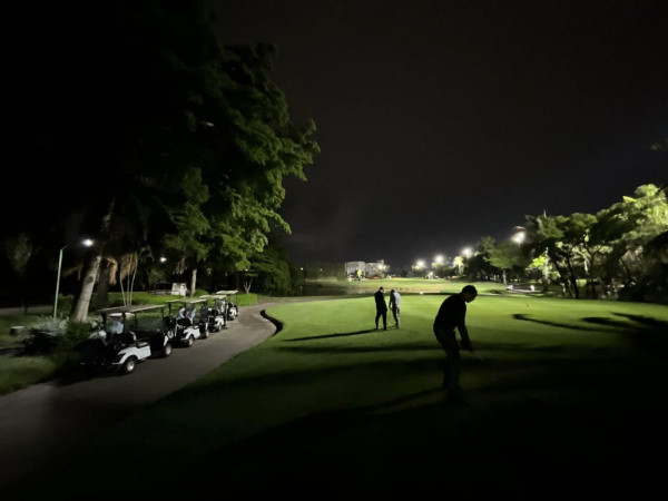 Summit Windmill Golf Club nbsp 3 people people golfing golf cart golf course and twilight