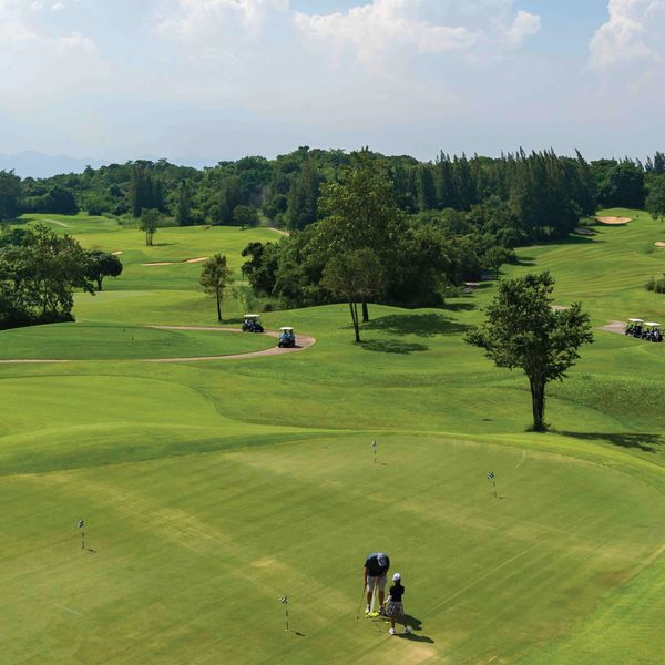 Banyan Golf Club Hua Hin 2 people people golfing golf buggy and golf course