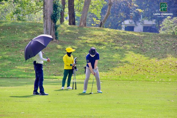 Laem Chabang International Country Club 3 people people standing grass and LAEM CHABANG COUNTRY CLUB