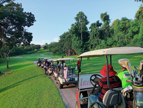 Burapha Golf amp Resort Thailand nbsp 5 people people golfing golf cart golf course and text